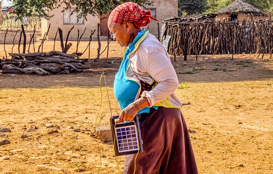 Community members displaying solar panels in South Africa.